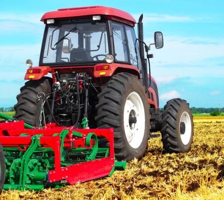Tractor with soil tiller attachment